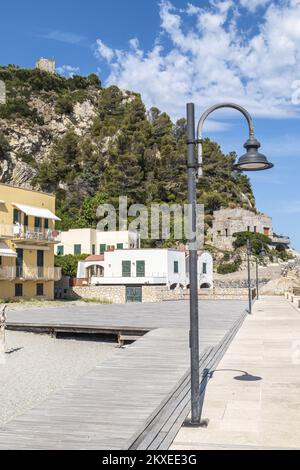Varigotti, Italy - 10-07-2021: The promenade of Varigotti, with houses with colored facades Stock Photo