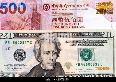 Close up of a twenty US Dollar bill and a five hundred Hong Kong Dollar bank note. Stock Photo