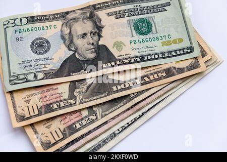 Various US dollar bills isolated in a white background. Stock Photo