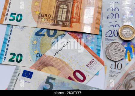 Close up of Euro bank notes and Great Britain Pound sterling notes and coins. Stock Photo