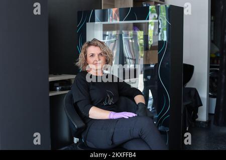 20.04.2020., Zagreb, Croatia - Tanja Ana Kauzljar, owner of the hairdressing salon Danu, took all measures and adapted to the coronavirus situation. She has installed partitions in the salon, disinfectants will be used and the temperature will be measured at the entrance to the salon. Workers will wear visors and masks while working in the salon. Photo: Luka Stanzl/PIXSELL Stock Photo