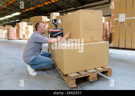 man with boxes in warehouse Stock Photo