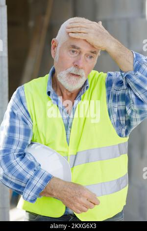 senior architect or engineer stressful keeping hands on head Stock Photo
