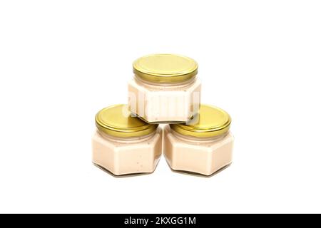 Three glass jars with jam on a white background. Stock Photo