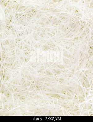 Texture of white paper filler. Shredded Paper Packing Material. White Spaghetti shredded packing paper used to protect fragile object while in transpo Stock Photo
