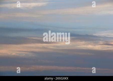 Soft lines of clouds in the sky at sunset Stock Photo