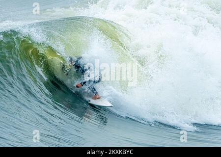 Surfer getting tubed at Jacksonville Beach in Northeast Florida. (USA) Stock Photo