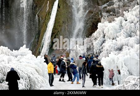 People spend Valentine's Day in nature at the beautiful Krcic waterfall, in Kovacica near Knin, although it is surrounded by ice due to low temperatures, it is full of visitors. Stock Photo