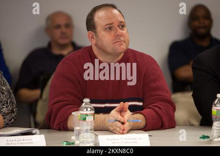 Flooding   Hurricane/Tropical Storm - Neptune, N. J. , Nov. 16, 2011   Matthew Furlong, Disability Accommodations Coordinator for DeVry University, listens to a presentation by FEMA Federal Coordinating Officer FCO William Vogel, during a tour for private sector partners at FEMA's Joint Field Office (JFO) in Neptune. Lead by Susan Langhoff, FEMA Assistant External Affairs Officer for Private Sector, leaders and members of New Jersey's private sector toured the FEMA JFO in Neptune. FEMA encourages the involvement of the private sector before and after a disaster. New Jersey Hurricane Irene. Pho Stock Photo