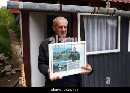 Zoran Mladic in front of the house with photos of his cousin Ratko Mladic, in Bozanovici, Bosnia and Herzegovina, on June 07, 2021. The village of Bozanovici near Kalinovik is the birthplace of war criminal Ratko Mladic. The villagers still support the war criminal Ratko Mladic and they hope that the court in The Hague will acquit him of all charges. The final verdict against Ratko Mladic, former commander of the Republika Srpska Army's (VRS) General Staff, who is charged with the most serious war crimes committed in Bosnia and Herzegovina (1992-1995), including genocide, will be handed down o Stock Photo