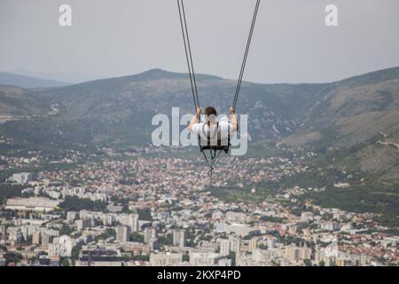 A new attraction of the Fortica adventure park, which gathers more and more domestic and foreign tourists every day, has recently been a swing made above Mostar. The swing is located 15 meters above the ground and 10 meters long swing is the largest swing in Bosnia and Herzegovina. It is intended for adults and is located under a glass lookout with a view of Mostar, which makes swinging even more interesting., in Mostar, Bosnia and Herzegovina, on June 20, 2021. Photo: Denis Kapetanovic/PIXSELL Stock Photo
