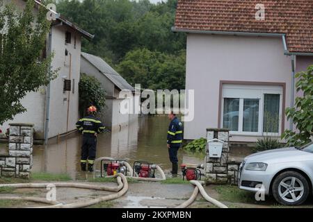 Firefighters drain water from house after flood caused by the storm that hit Slavonia region, in Nasice, Croatia, on July 19, 2021. Photo: Dubravka Petric/PIXSELL Stock Photo