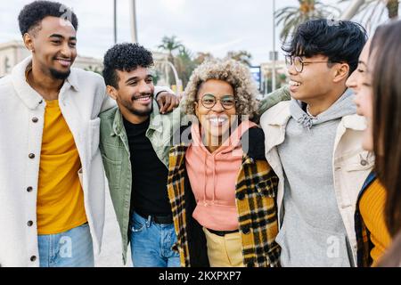 Multiracial young friends having fun in city street Stock Photo