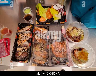 appetizing trays of oriental food with sushi, prawns, various fried for dinner or lunch Stock Photo