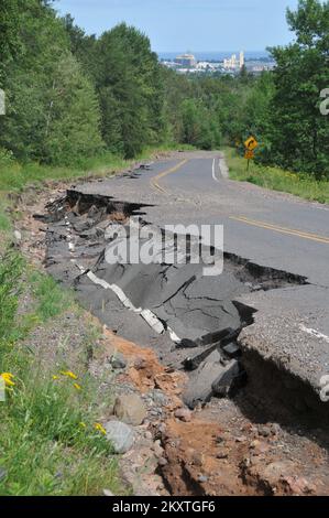 Flooding   Severe Storm - Duluth, Minn. , July 23, 2012   Duluth's Haines Road is one of many streets and highways damaged by June's strong storms and flooding in Minnesota. FEMA will pay up to 75 percent of eligible costs to repair public infrastructure damaged by the flooding. Norman Lenburg/FEMA. Minnesota Severe Storms And Flooding. Photographs Relating to Disasters and Emergency Management Programs, Activities, and Officials Stock Photo