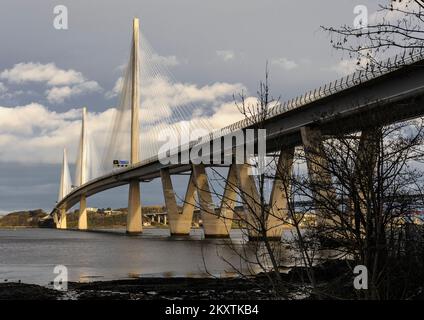 Oblique view along upstream side of Queensferry Crossing bridge across the Firth of Forth seen from below the bridge in South Queensferry Stock Photo