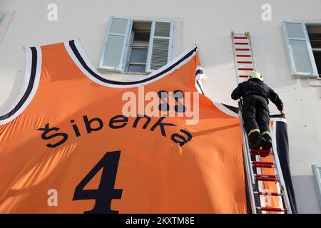 Giant Drazen Petrovic, number 4, basketball jersey of Sibenka basketball club is lifted by a fireman crane at building on the occasion of his 57th birthday in Sibenik , Croatia on October 21, 2021. Photo: Dusko Jaramaz/PIXSELL Stock Photo