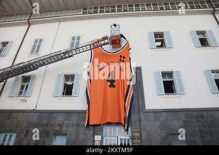 Giant Drazen Petrovic, number 4, basketball jersey of Sibenka basketball club is lifted by a fireman crane at building on the occasion of his 57th birthday in Sibenik , Croatia on October 21, 2021. Photo: Dusko Jaramaz/PIXSELL Stock Photo