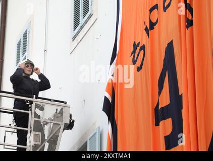 Giant Drazen Petrovic, number 4, basketball jersey of Sibenka basketball club is lifted by a fireman crane at building on the occasion of his 57th birthday in Sibenik , Croatia on October 21, 2021. Photo: Dusko Jaramaz/PIXSELL Stock Photo