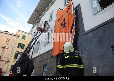 Giant Drazen Petrovic, number 4, basketball jersey of Sibenka basketball club is lifted by a fireman crane at building on the occasion of his 57th birthday in Sibenik , Croatia on October 21, 2021. Photo: Dusko Jaramaz/PIXSELL Stock Photo