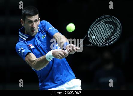 MADRID, SPAIN - DECEMBER 03: Novak Djokovic of Serbia plays a backhand to Marin Cilic of Croatia during the Davis Cup Semi Final match between Croatia and Serbia at Madrid Arena on December 03, 2021 in Madrid, Spain. Photo: Sanjin Strukic/PIXSELL  Stock Photo