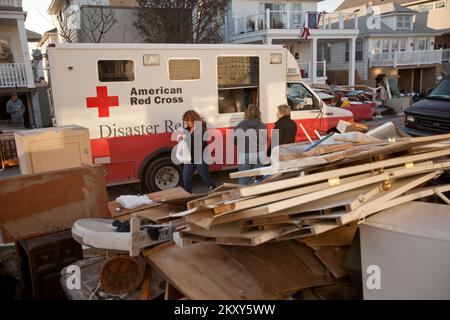 Long Island, N.Y., Nov. 9, 2012   The American Red Cross delivers food to Hurricane Sandy survivors in a Long Island neighborhood. The hurricane created widespread flooding, power outages and devastation to the area. FEMA is working with state and local officials to assist residents who were affected by Hurricane Sandy. Andrea Booher/FEMA. New York Hurricane Sandy. Photographs Relating to Disasters and Emergency Management Programs, Activities, and Officials Stock Photo