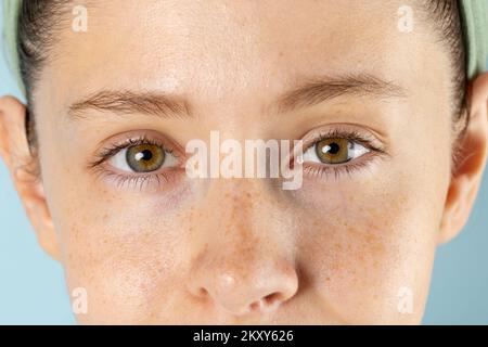 Close up of eyes of caucasian woman on blue background Stock Photo