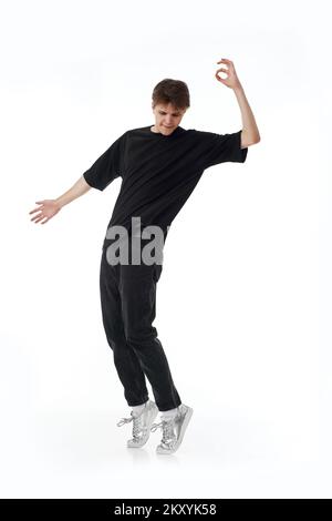 young man in black t-shirt and jeans dancing Stock Photo