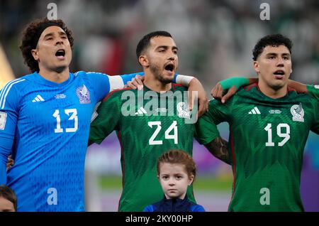 Left to right, Mexico's Guillermo Ochoa, Luis Chavez and Jorge Sanchez sing the national anthem before the FIFA World Cup Group C match at the Lusail Stadium in Lusail, Qatar. Picture date: Wednesday November 30, 2022. Stock Photo