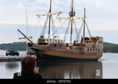 Attractive Galleon Tirena moored to the Sibenik waterfront attracts the eyes of passers-by. Dubrovnik's wooden sailing ship is a replica of a 16th century galley. Tirena was built in a specialized shipyard in Omis, a town known as the medieval Croatian 'pirate capital'. The construction itself proved to be very challenging, so the shipyard had to be expanded in order to complete the construction of the galley. Built according to the precise designs of the Dubrovnik galleon from the archives of the Dubrovnik Maritime Museum, Tirena is a 31m long and 5.7m wide galley, with a 15-meter mast, four  Stock Photo