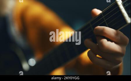 Girl playing semi-acoustic guitar at home. Stock Photo