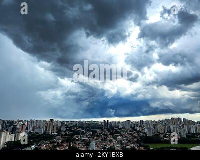 Dark and dramatic rain clouds over a city. Stock Photo