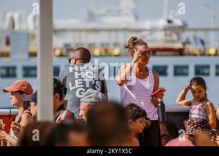 Tourists are seen on a ferry from Split to Supetar on the island of Brac, on June 22, 2022, in Split, Croatia. Photo: Zvonimir Barisin/PIXSELL Stock Photo