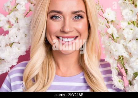 Close up photo of gorgeous cute lady beaming smile stand among white flowers walking spring park isolated on pink color background Stock Photo