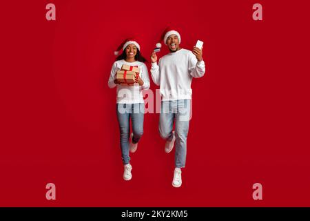 Excited black lovers buying christmas gifts for friends and family Stock Photo
