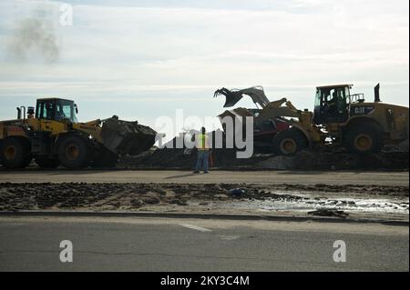 Far Rockaway, N.Y., Dec. 12, 2012   The U.S. Army Corps of Engineers is removing debris from Far Rockaway, Long Island beaches boardwalk. Using a fleet of front-end loaders, crawler excavators and dump trucks, the Army Corps is working block by block to clear debris and make way for new sand. Replenishing the beach falls under the New York Department of Parks and Recreation authority. Eliud Echevarria/FEMA. New York Hurricane Sandy. Photographs Relating to Disasters and Emergency Management Programs, Activities, and Officials Stock Photo