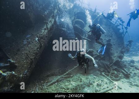 Scuba diver exploring the interior of a submerged wreck of Giannis D on September 30, 2022 in Hurghada, Red Sea, Egypt. In April 1983, Giannis D was loaded with lumber in Rijeka, Croatia, destined for Saudi Arabia and Yemen. The ship passed through the Mediterranean and through the Suez Canal. On 19 April 1983, it was approaching the Gobal Strait at full speed when it was seen to suddenly veer off course and crash heavily into the northwest corner of the Sha'ab Abu Nuhas ridge. The crew abandoned the ship and were safely rescued. The submerged wreck of Giannis D is located at a depth of 4 to 2 Stock Photo