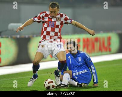Croatia's Ivica Olic and Greece's Georgios Samaras battle for the ball. Stock Photo