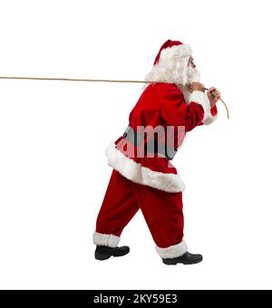 Santa claus pulls a rope to move something Stock Photo