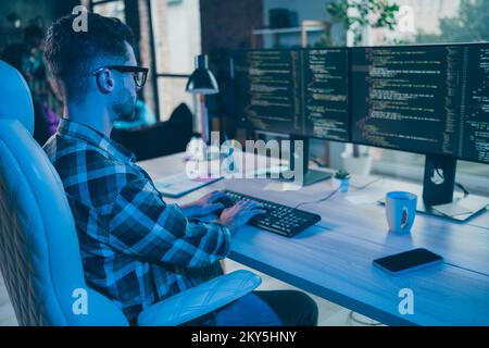 Photo of serious busy guy wear glasses writing safety code modern device indoors workstation workshop home Stock Photo