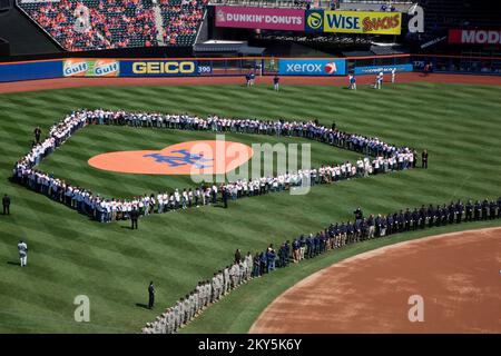 Flushing, N.Y., April 1, 2013   Hurricane Sandy first responders and volunteers were honored at Citi Field during the pre-game ceremony for Mets opening day. More than 500 first responders to Hurricane Sandy lined up on the field for the national anthem including FEMA representatives, police, firefighters, military personnel and Habitat for Humanity volunteers. Ashley Andujar/FEMA. New York Hurricane Sandy. Photographs Relating to Disasters and Emergency Management Programs, Activities, and Officials Stock Photo