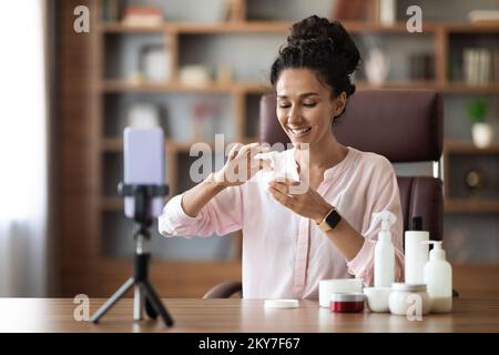 Attractive female beauty blogger recommending face care routine Stock Photo