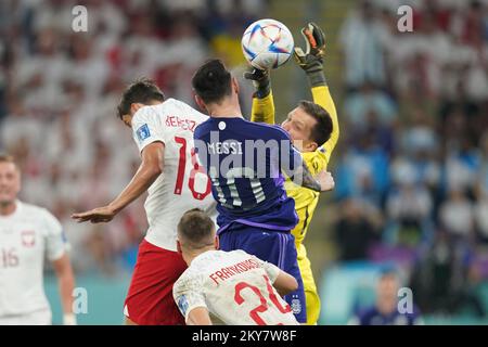 DOHA, QATAR - NOVEMBER 30: Player of Argentina Lionel Messi fights for the ball with player of Poland Bartosz Bereszyński and Wojciech Szczęsny during the FIFA World Cup Qatar 2022 group C match between Argentina and Poland at Stadium 974 on November 30, 2022 in Doha, Qatar. (Photo by Florencia Tan Jun/PxImages) Credit: Px Images/Alamy Live News Stock Photo