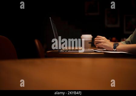 Close up hand asian woman holding pen in casual clothes working in cafe with laptop. Stock Photo