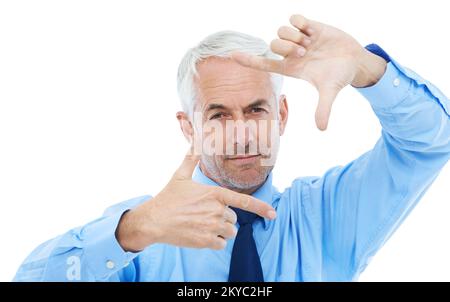 Hes got business success in his sights. Studio portrait of a mature businessman framing his face with his fingers. Stock Photo