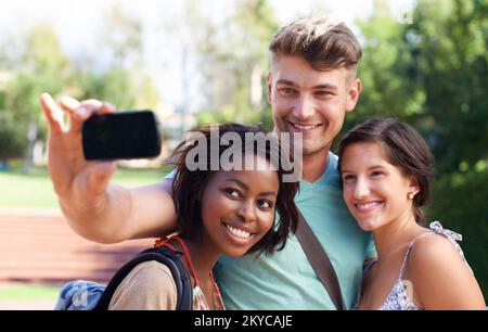 Connect with other students who want to get somewhere in life too - College application advertisements. A group of students taking a self-portrait on Stock Photo