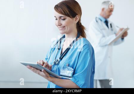 Using digital tools for your diagnosis. A female doctor working on a digital tablet. Stock Photo