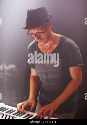 A keyboardist rocking out on stage. This concert was created for the sole purpose of this photo shoot, featuring 300 models and 3 live bands. All Stock Photo