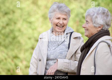 Friends for Life. Cropped view of two senior woman smiling and chatting outdoors. Stock Photo