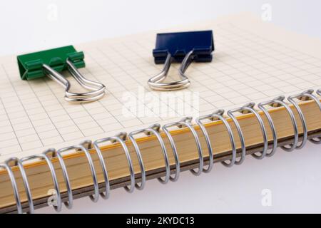 Office notebook and different paper clips on blue background Stock ...